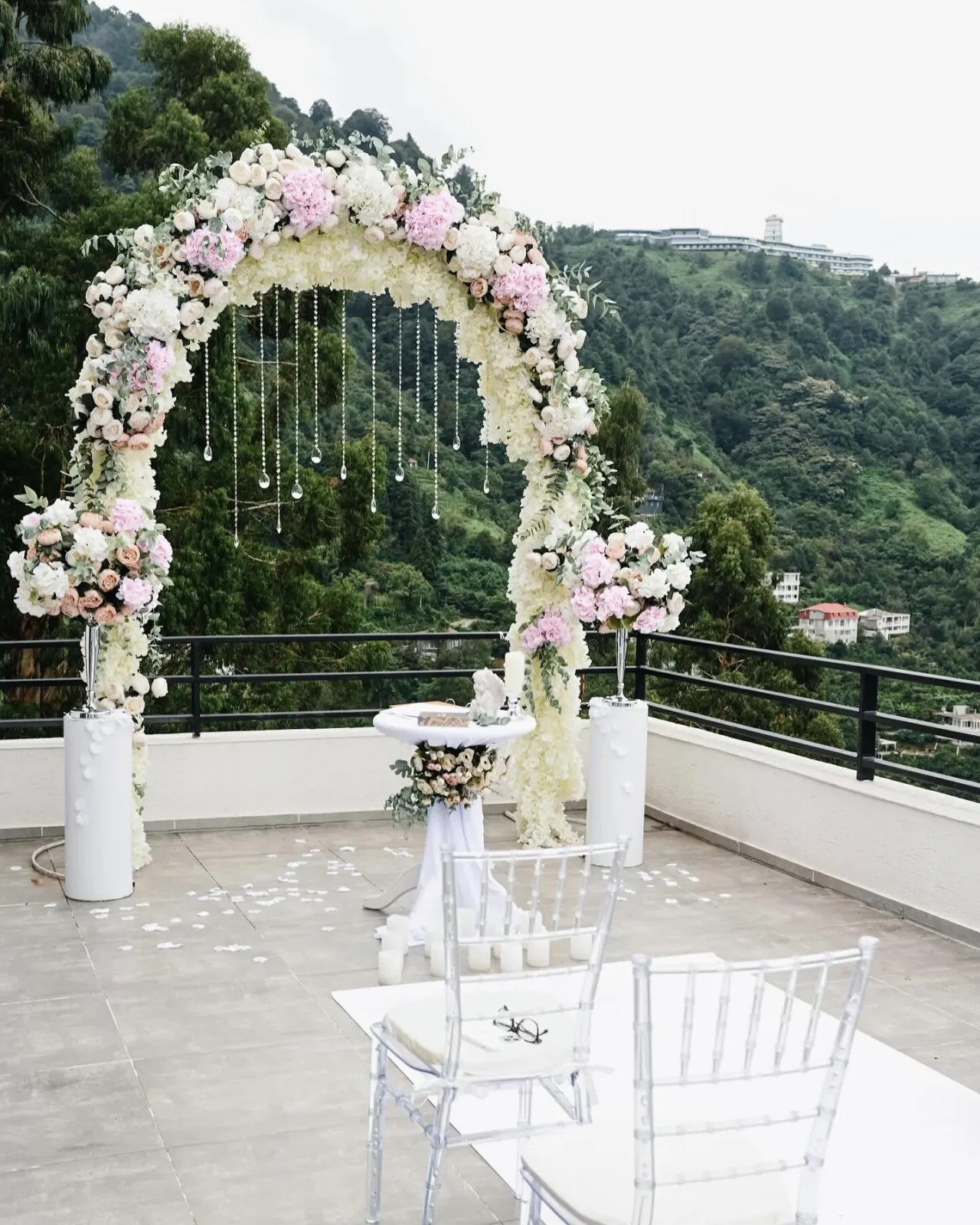White and pink flower arch on a mountain terrace